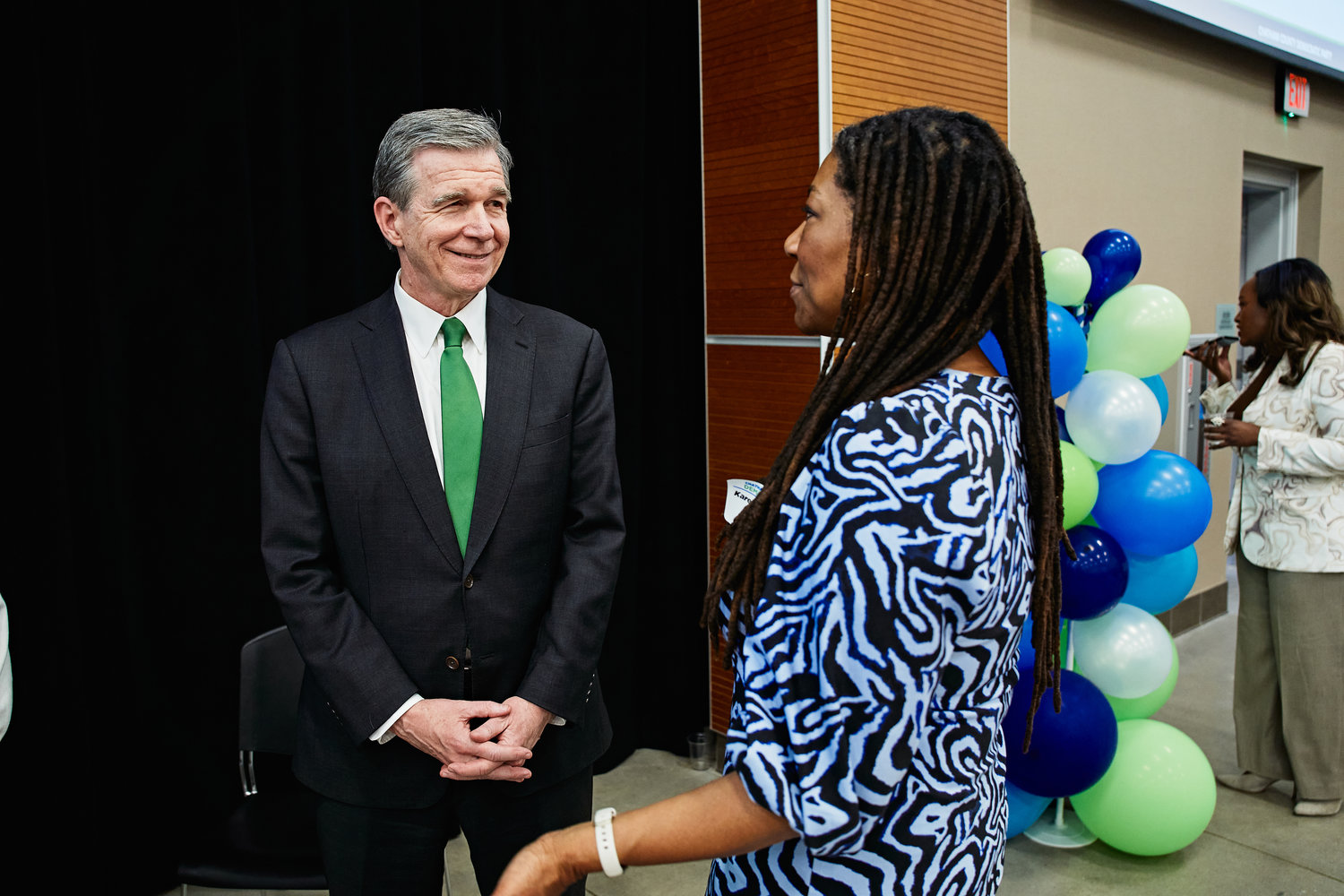 Gov. Roy Cooper greets Chatham County Board of Commissioners Chairperson Karen Howard.